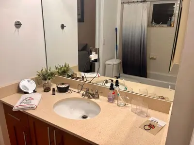 a bathroom with a sink and a large mirror at Fort Lauderdale Oasis private rooms in shared house in Fort Lauderdale
