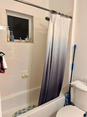 a bathroom with a shower curtain and a toilet at Fort Lauderdale Oasis private rooms in shared house in Fort Lauderdale