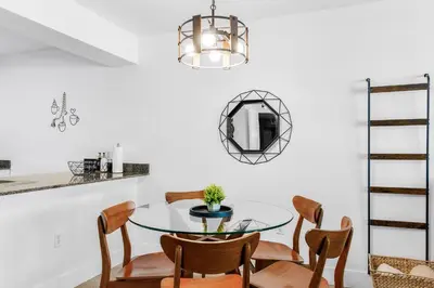 a dining room with a glass table and chairs at Condo Stylish and Minimalist w Highlights Amenities! in Miami