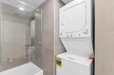 a bathroom with a toilet and a sink and a mirror at Condo Stylish and Minimalist w Highlights Amenities! in Miami