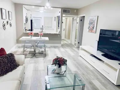 a living room with a white couch and a tv at Modern 1BR 1BA Condo 1Block to Aventura Mall in Aventura