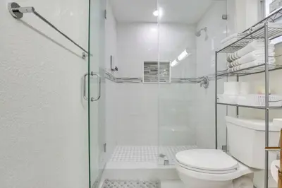 a bathroom with a toilet and a glass shower at Oasis of Sunrise in Sunrise
