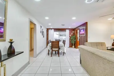 a living room with a table and chairs at Oasis of Sunrise in Sunrise