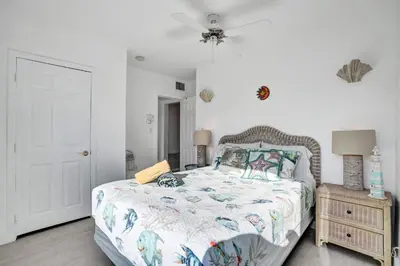 a bedroom with a bed and a ceiling fan at Sunset Oceanfront Paradise in Hollywood