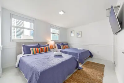 a bedroom with two beds and a couch at Open the Window and Enjoy the Sea Breeze at Exclusive Condo! in Miami
