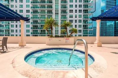 a hot tub on the roof of a building at Open the Window and Enjoy the Sea Breeze at Exclusive Condo! in Miami