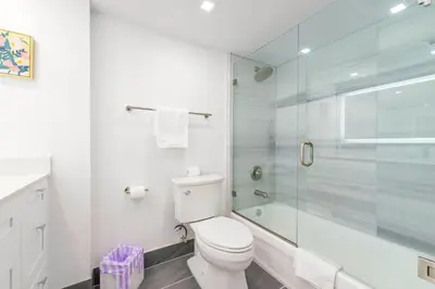 a bathroom with a toilet and a glass shower at Open the Window and Enjoy the Sea Breeze at Exclusive Condo! in Miami