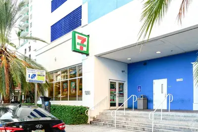 a blue and white building with a car parked outside at Open the Window and Enjoy the Sea Breeze at Exclusive Condo! in Miami
