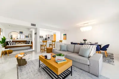 a living room with a couch and a table at Open the Window and Enjoy the Sea Breeze at Exclusive Condo! in Miami