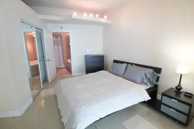 a bedroom with a large bed and a mirror at Castle L5 Oceanview Double-loft with pool, beach access, tennis, free parking! in Miami Beach
