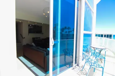 a living room with a couch and chairs on a balcony at Castle L5 Oceanview Double-loft with pool, beach access, tennis, free parking! in Miami Beach