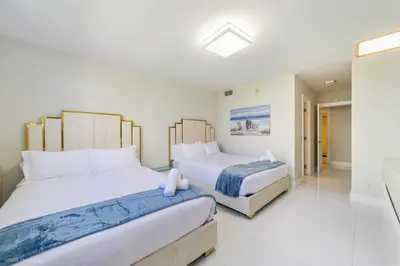 a bedroom with two beds and a bathroom at Sunny Isles Beachfront Oasis, Modern & Spacious in Sunny Isles Beach