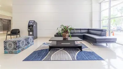 a living room with a couch and a table at Sunny Isles Beachfront Oasis, Modern & Spacious in Sunny Isles Beach