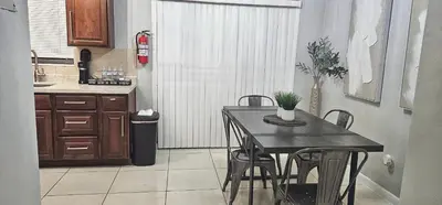 a kitchen with a table and chairs in a kitchen at Big TV 2 Bedroom Apartment Cooper City in Cooper City