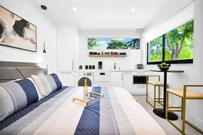 a living room with a couch and a table at Modern Oasis Near Design District, Wynwood in Miami