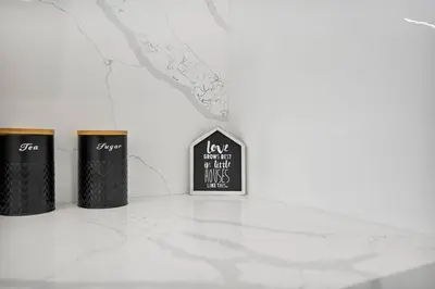 three trash cans sitting on top of a counter at Modern Oasis Near Design District, Wynwood in Miami