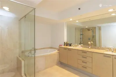 a bathroom with a tub and a shower and a sink at Elegant Resort - Beautiful Views in Hallandale Beach