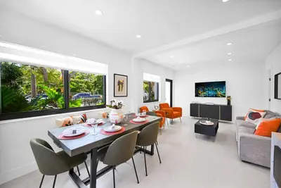 a living room with a table and chairs and a couch at Modern Private Oasis by Design District & Wynwood in Miami