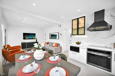 a kitchen and a living room with a table and chairs at Modern Private Oasis by Design District & Wynwood in Miami