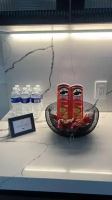 a counter with two cans of coke and water bottles at Modern Private Oasis by Design District & Wynwood in Miami
