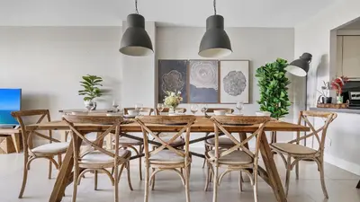 a dining room with a wooden table and chairs at Absolute Beach Bliss, Chic & Expansive Retreat in Sunny Isles Beach