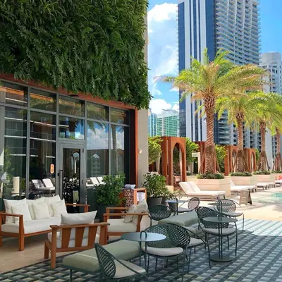 a patio with tables and chairs in front of a building at Luxury King Suite W City view at SLS Brickell in Miami