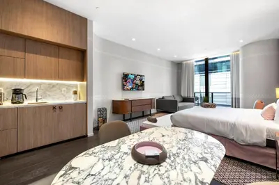 a hotel room with a bed and a kitchen at Luxury King Suite W City view at SLS Brickell in Miami