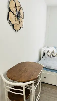 a room with a wooden table and a bed at The Tiny Red Mini Studio At Little Havana in Miami