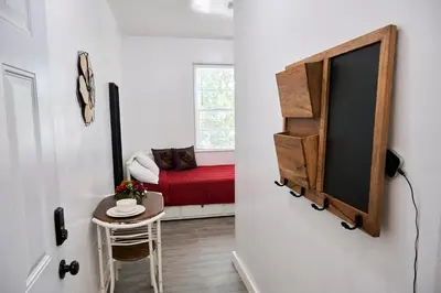 a room with a small table and a red bed at The Tiny Red Mini Studio At Little Havana in Miami