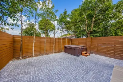 a backyard with a fence and a trash can at Up to 12 guest Modern Villa near Wynwood! 27 in Miami