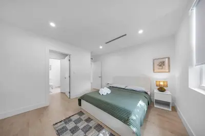 a bedroom with a bed in a white room at Up to 12 guest Modern Villa near Wynwood! 27 in Miami