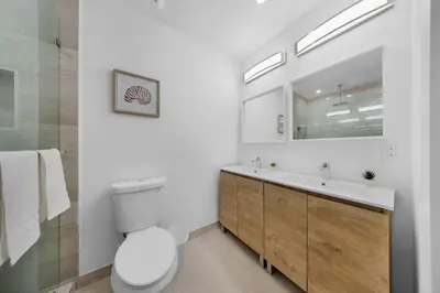 a white bathroom with a toilet and a sink at Up to 12 guest Modern Villa near Wynwood! 27 in Miami
