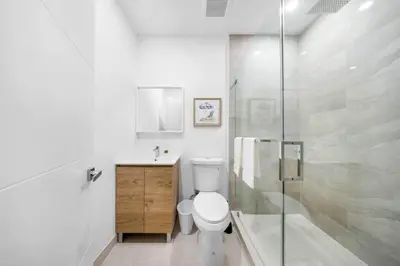 a bathroom with a toilet and a glass shower at Up to 12 guest Modern Villa near Wynwood! 27 in Miami