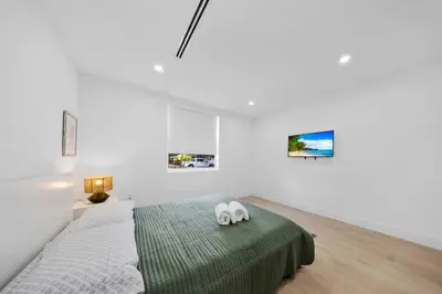 a bedroom with a bed with a stuffed animal on it at Up to 12 guest Modern Villa near Wynwood! 27 in Miami