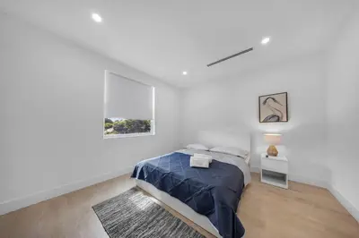 a white bedroom with a bed and a rug at Up to 12 guest Modern Villa near Wynwood! 27 in Miami