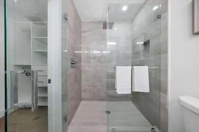 a bathroom with a shower with a glass door at Up to 12 guests! Modern Villa near Wynwood 29! in Miami