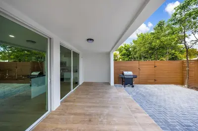 an open patio with a wooden fence and a bench at Up to 12 guests! Modern Villa near Wynwood 29! in Miami