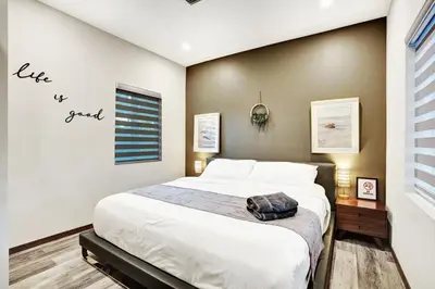 a bedroom with a bed with a sign that reads live my friend at Ultimate Retreat 6BR & 3BA Villa near Beach in Dania Beach