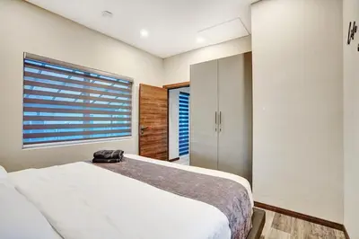 a bedroom with a bed and a large window at Ultimate Retreat 6BR & 3BA Villa near Beach in Dania Beach