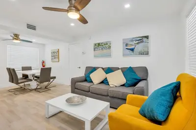 a living room with a couch and a table at ULTRA peaceful 2 bedroom beach&boardwalk apartment in Hollywood