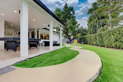 an image of a house with a lawn at The Palms Villa with Cinema, Game Table, Pool, Jacuzzi , Giant Chess, 8 Beds in Miami