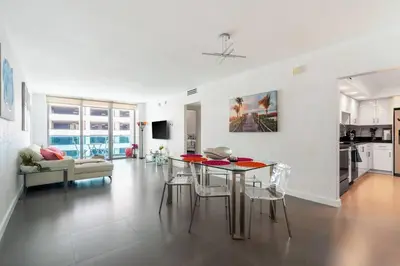 a kitchen and living room with a table and chairs at Welcome to our beach home! in Hollywood