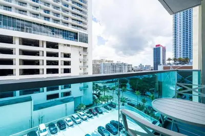an apartment balcony with a view of a parking lot at Welcome to our beach home! in Hollywood