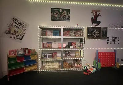 a room with a book shelf filled with books at Luxury Mansion, Game Room, Pool, Rooftop, Skyline, Walk to Las Olas in Fort Lauderdale