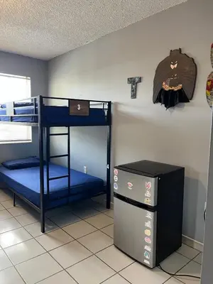 a room with two bunk beds and a refrigerator at Beds & Sheets little Havana in Miami
