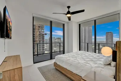 a bedroom with a bed and large windows at New 2-Bdrm Downtown Miami Apartment with Bay Vista in Miami