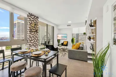 a living room with a table and chairs and a couch at Beautiful Apartment with gym and amazing Pool in Miami