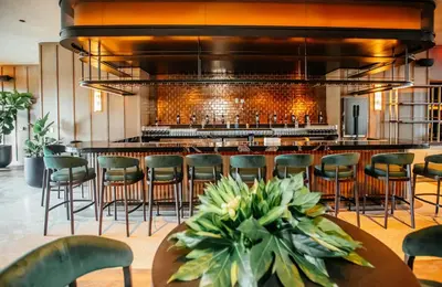 a bar in a restaurant with chairs and a counter at New unit 28th Floor with Unbeatable Bayside Views in Miami