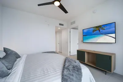 a bedroom with a bed and a flat screen tv at New unit 28th Floor with Unbeatable Bayside Views in Miami