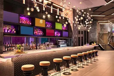 a bar with a row of stools in a restaurant at Luxury One-Bedroom w Top Amenities! in Miami